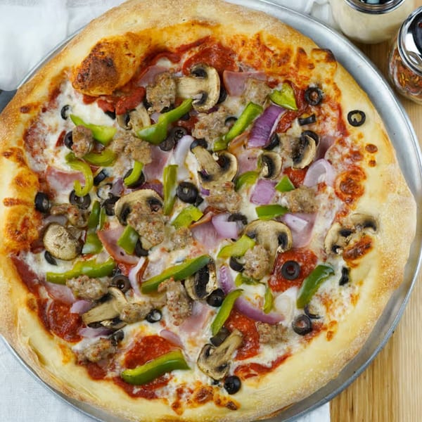 Halftime Pizza's supreme pizza with sausage, pepperoni, mushrooms, olives, onions, and bell peppers.